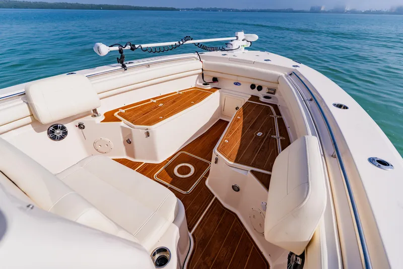 Slide: The Image of 2021 Grady-White Canyon 306 boat interior with teak flooring and cushioned seating. - 8