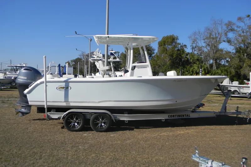 The Image of 2022 Sea Hunt Ultra 234 boat on trailer, side view, outdoors. - 0