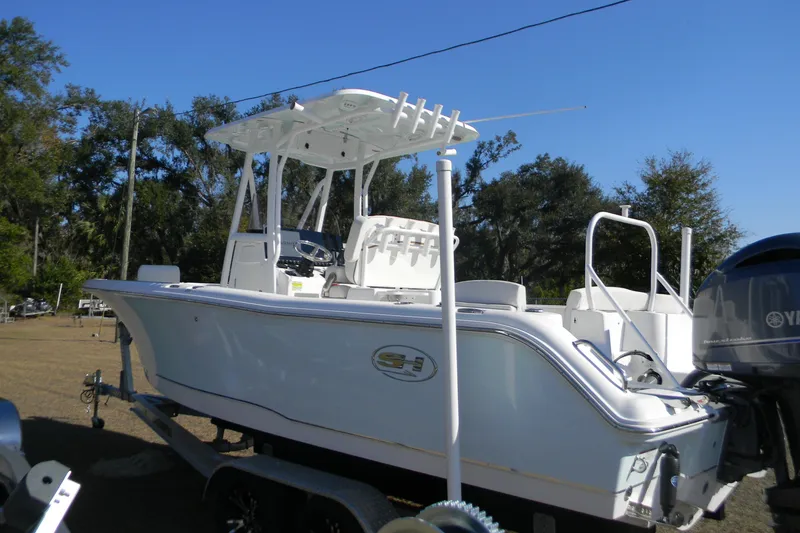 Slide: The Image of 2022 Sea Hunt Ultra 234 boat on trailer, featuring sleek design and Yamaha outboard motor. - 1