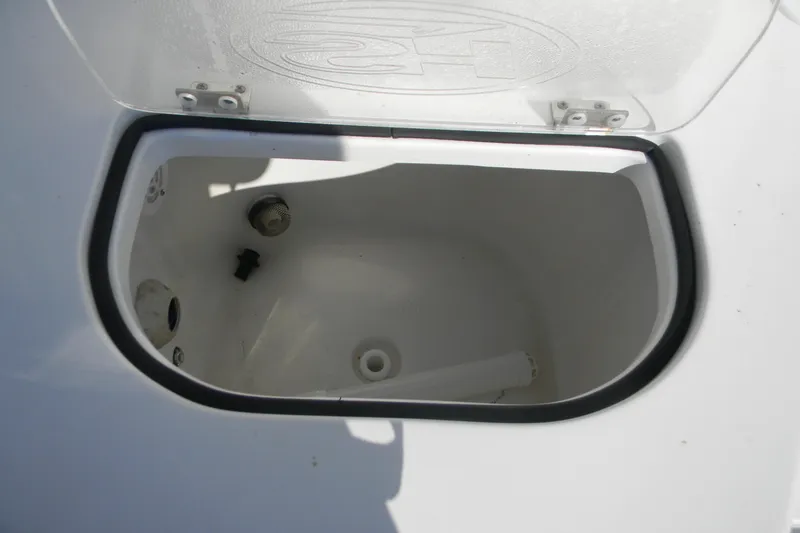 Slide: The Image of Open storage compartment on 2022 Sea Hunt Ultra 234 boat. - 12