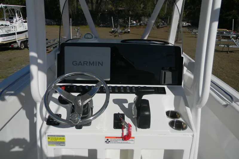 Slide: The Image of 2022 Sea Hunt Ultra 234 boat console with Garmin navigation system and steering wheel. - 13