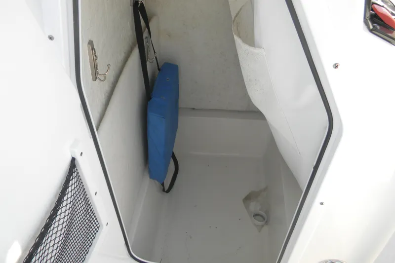 Slide: The Image of Interior storage compartment of 2022 Sea Hunt Ultra 234 boat with blue cushion. - 4