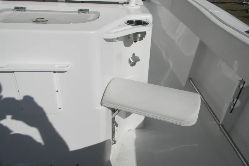 Slide: The Image of 2022 Sea Hunt Ultra 234 boat interior with foldable seat and cup holder. - 6