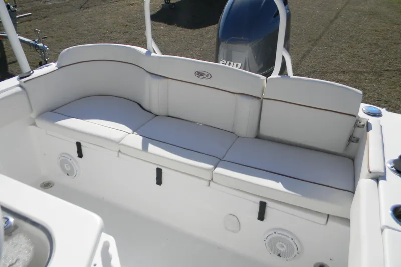 Slide: The Image of 2022 Sea Hunt Ultra 234 boat with white cushioned seating and visible engine. - 8
