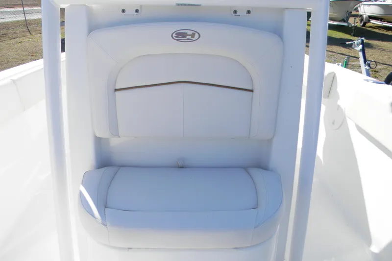Slide: The Image of 2022 Sea Hunt Ultra 234 boat seat with white cushioned backrest. - 9