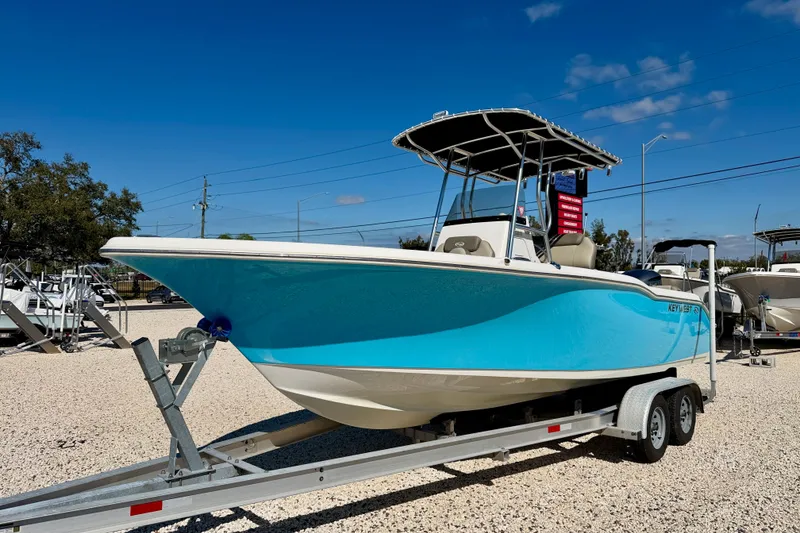 Slide: The Image of 2023 Key West 239 FS boat on trailer, vibrant blue hull, sunny day. - 1
