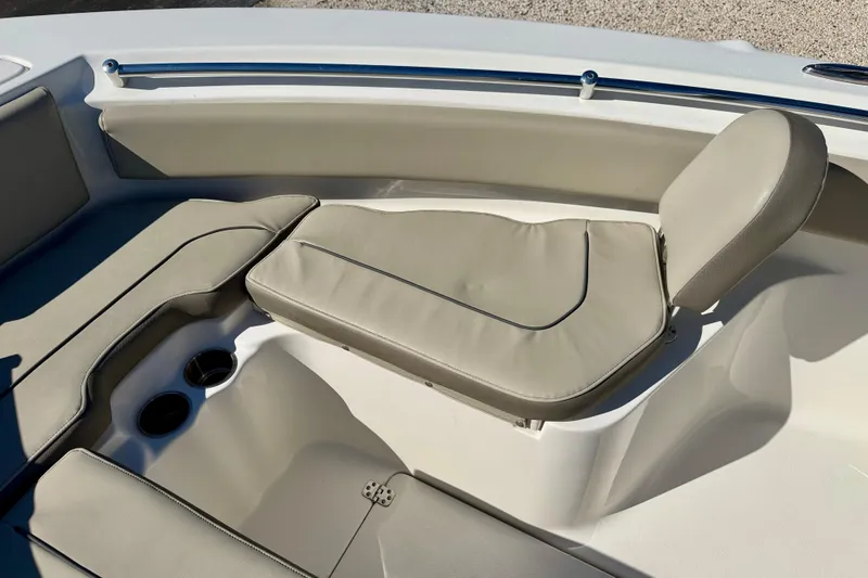 Slide: The Image of 2023 Key West 239 FS boat interior with beige seating and cup holders. - 10