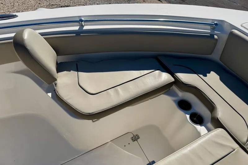 Slide: The Image of 2023 Key West 239 FS boat interior with cushioned seating and cup holders. - 11