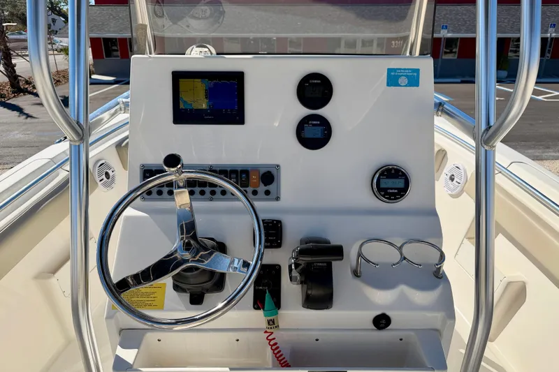 Slide: The Image of 2023 Key West 239 FS boat console with steering wheel and navigation instruments. - 16