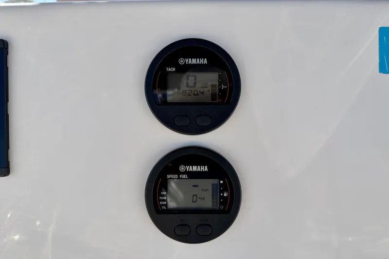 Slide: The Image of Digital gauges on a 2023 Key West 239 FS boat dashboard, displaying tachometer and speed fuel readings. - 20