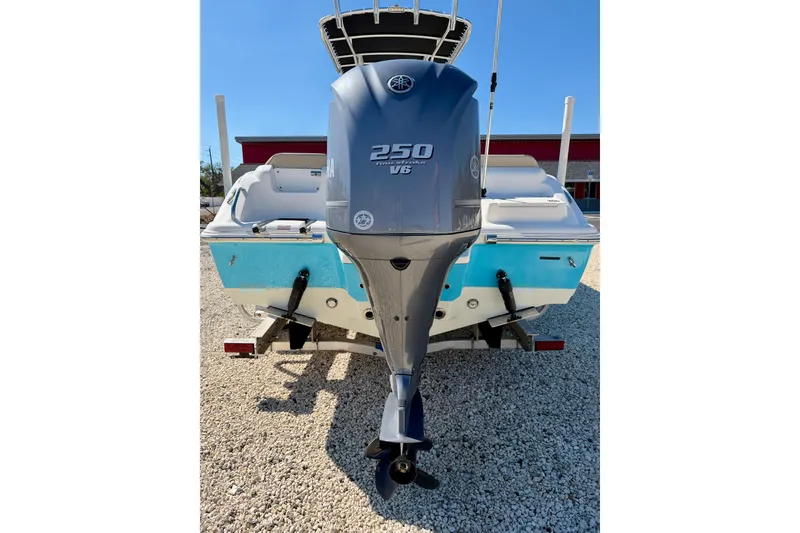 Slide: The Image of 2023 Key West 239 FS boat with Yamaha 250 V6 engine, rear view on gravel. - 24