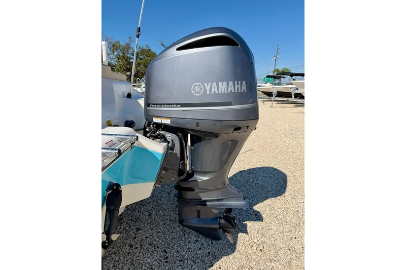 Slide: The Image of 2023 Key West 239 FS boat with Yamaha outboard motor on gravel lot. - 25