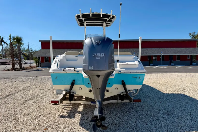 Slide: The Image of 2023 Key West 239 FS boat with Yamaha 250 V6 engine, parked outdoors. - 6