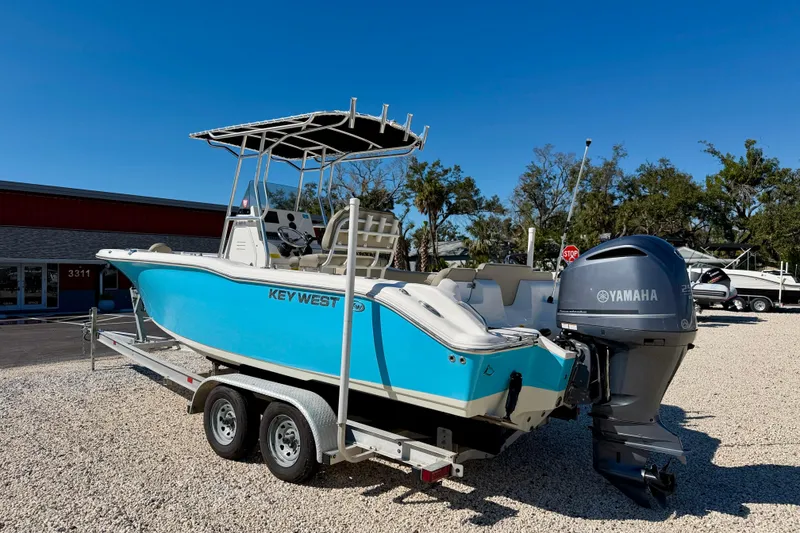 Slide: The Image of 2023 Key West 239 FS boat with Yamaha engine on trailer, parked outdoors. - 7