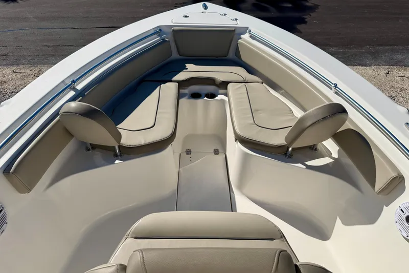 Slide: The Image of 2023 Key West 239 FS boat interior with beige seating and cup holders. - 8