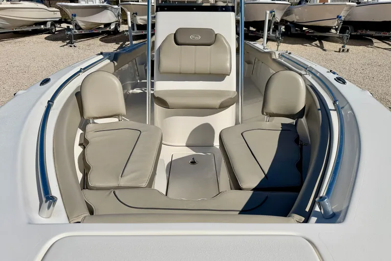 Slide: The Image of 2023 Key West 239 FS boat interior with cushioned seating and sleek design. - 9