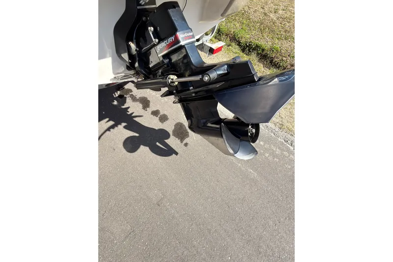 Slide: The Image of 2003 Crownline 180 BR boat with Mercury MerCruiser outboard motor on pavement. - 12