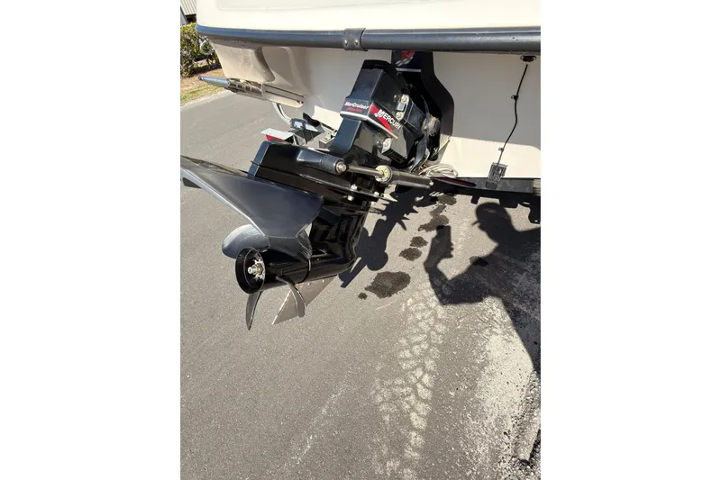 Slide: The Image of 2003 Crownline 180 BR boat with MerCruiser outdrive on pavement. - 13