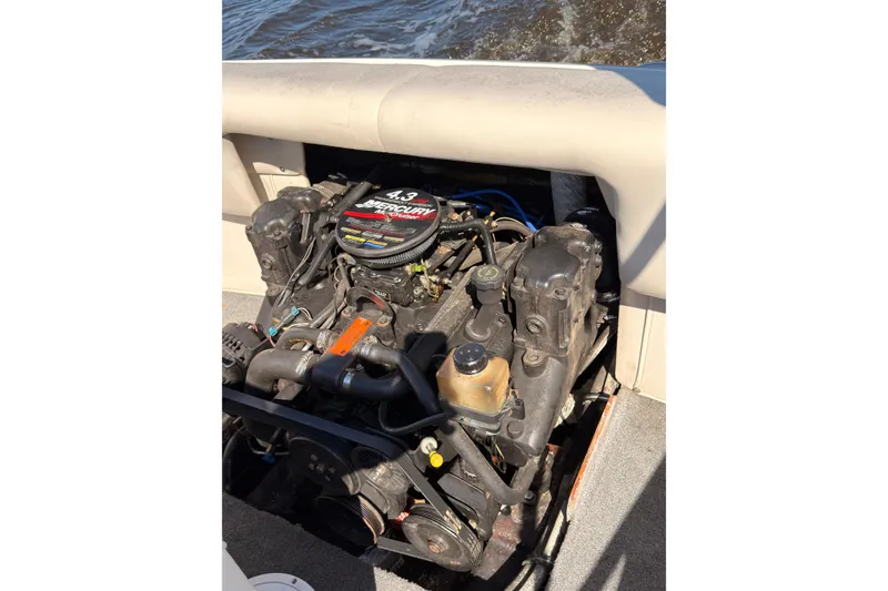 Slide: The Image of 2003 Crownline 180 BR boat engine, featuring a 4.3 Mercury motor, on water. - 14