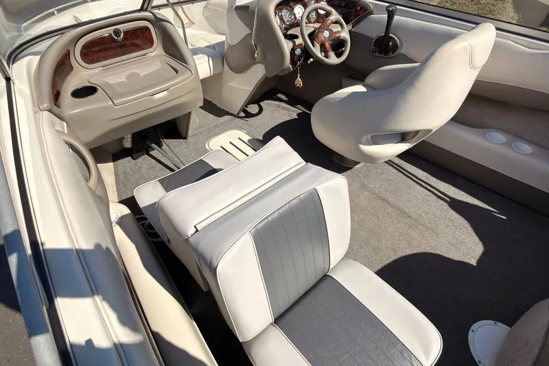 Slide: The Image of Interior of 2003 Crownline 180 BR boat with beige and gray seating. - 5