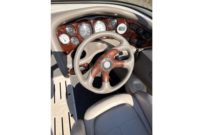 Slide: The Image of 2003 Crownline 180 BR boat dashboard with wood accents and steering wheel. - 9