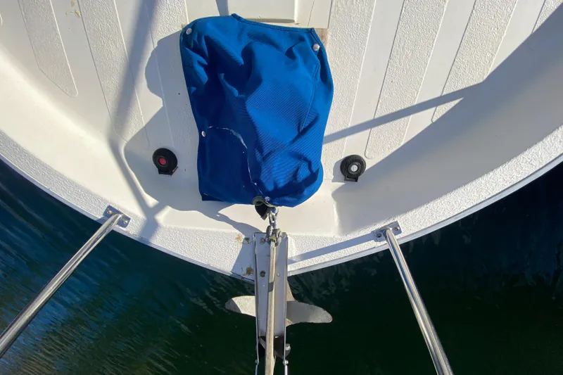 Slide: The Image of Bow of a 1988 Nordic Tug 26 with blue cover and anchor. - 6