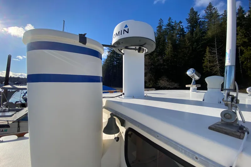 Slide: The Image of 1988 Nordic Tug 26 with Garmin radar, docked near forested shoreline. - 7