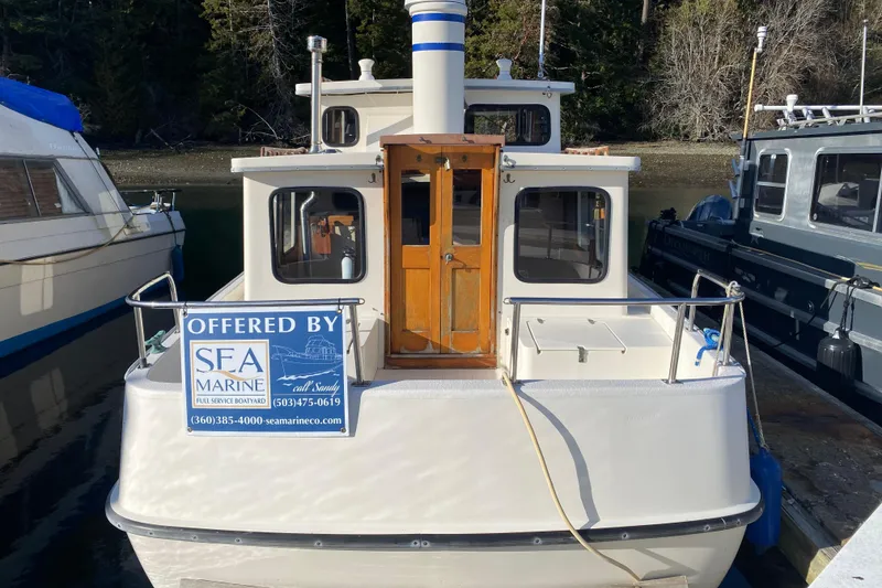 Slide: The Image of 1988 Nordic Tug 26 docked, offered by SEA Marine, with contact information displayed. - 8