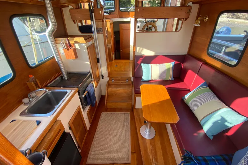 Slide: The Image of Cozy interior of a 1988 Nordic Tug 26 with kitchen and seating area. - 9