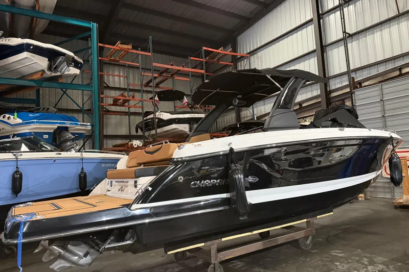 The Image of 2022 Chaparral 307 SSX boat in storage, showcasing sleek design and modern features. - 0