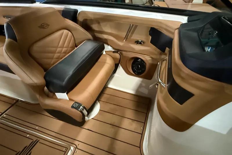 Slide: The Image of 2022 Chaparral 307 SSX boat interior with luxurious tan seating and sleek design. - 12