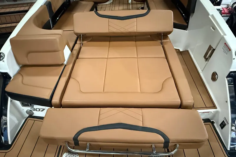 Slide: The Image of 2022 Chaparral 307 SSX boat interior with tan leather seating and sleek design. - 15