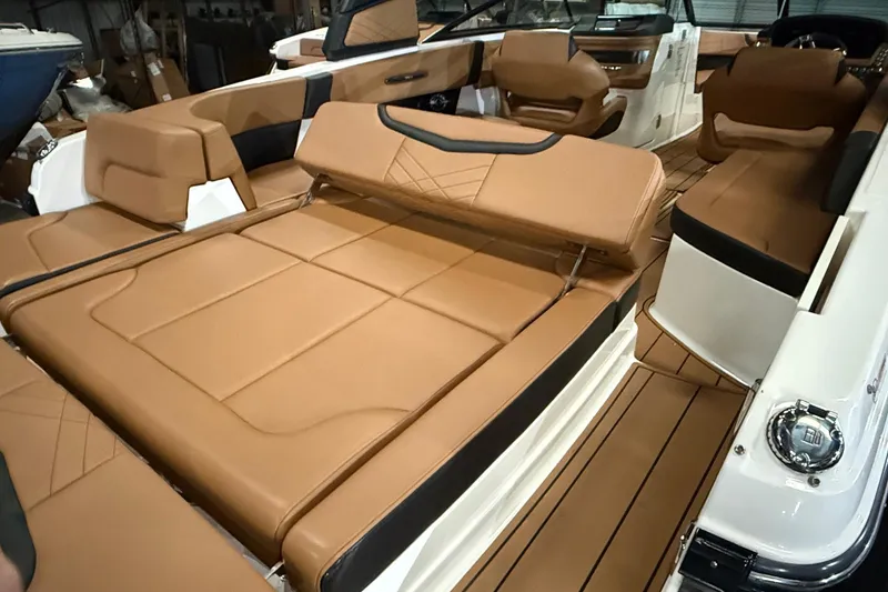 Slide: The Image of 2022 Chaparral 307 SSX boat interior with luxurious tan seating and modern design. - 16