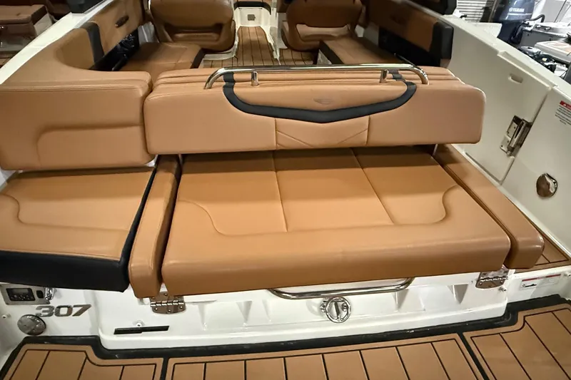 Slide: The Image of 2022 Chaparral 307 SSX boat interior with tan leather seating and sleek design. - 17