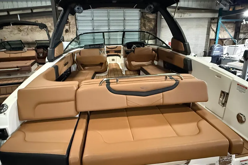 Slide: The Image of 2022 Chaparral 307 SSX boat interior with tan leather seating and modern design. - 18