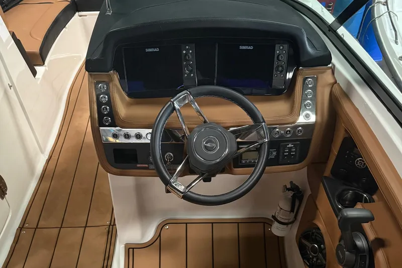 Slide: The Image of 2022 Chaparral 307 SSX boat dashboard with steering wheel and navigation controls. - 4