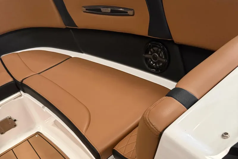 Slide: The Image of 2022 Chaparral 307 SSX boat interior with tan leather seating and speaker system. - 5