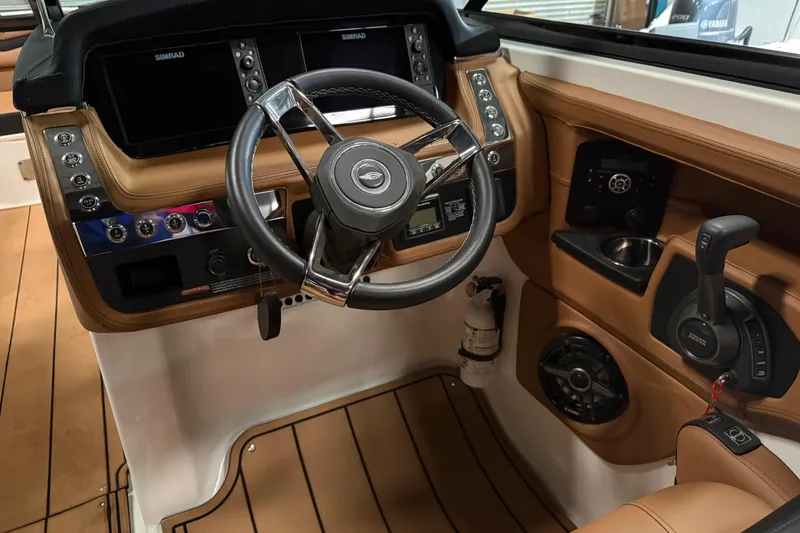 Slide: The Image of 2022 Chaparral 307 SSX boat cockpit with steering wheel and control panel. - 7