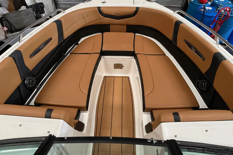 Slide: The Image of 2022 Chaparral 307 SSX boat interior with tan leather seating and sleek design. - 9
