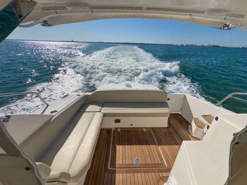 Slide: The Image of Rear view of Pursuit SC 365i Sport Coupe on the water. - 10