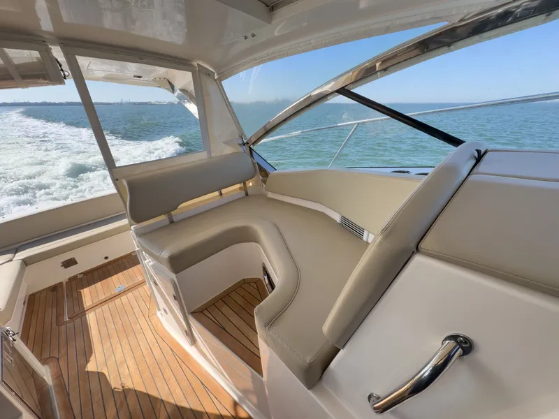 Slide: The Image of Interior of 2015 Pursuit SC 365i Sport Coupe on the water. - 12