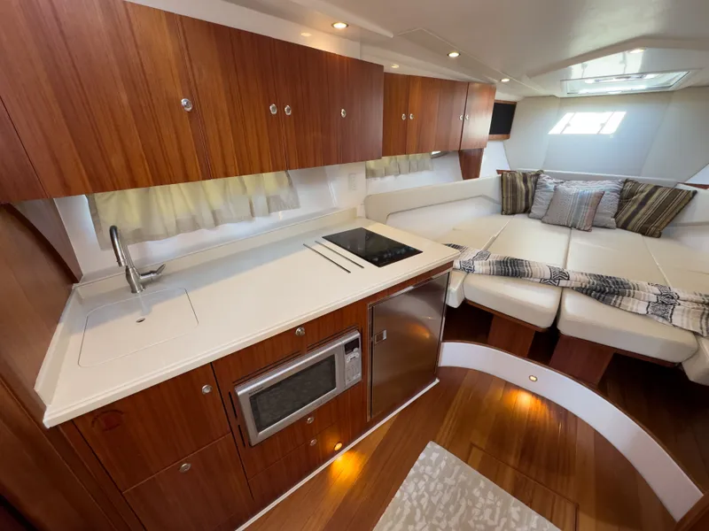 Slide: The Image of Interior of 2015 Pursuit SC 365i Sport Coupe with kitchen and seating area. - 22