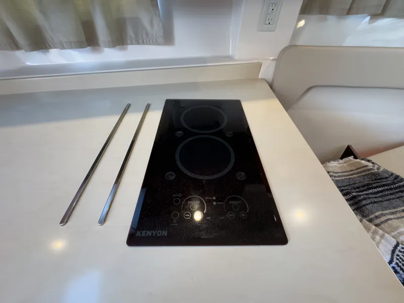 Slide: The Image of Kitchen area in 2015 Pursuit SC 365i Sport Coupe with Kenyon cooktop. - 30