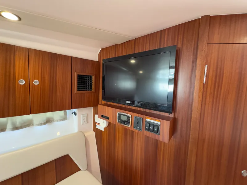 Slide: The Image of Interior of 2015 Pursuit SC 365i Sport Coupe with TV and wood paneling. - 34