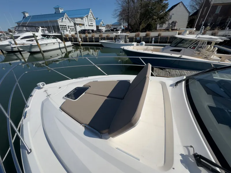 Slide: The Image of 2015 Pursuit SC 365i Sport Coupe docked, featuring sun deck. - 49
