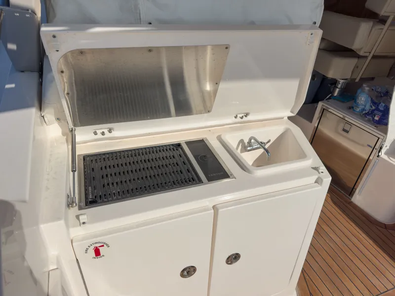 Slide: The Image of Galley on 2015 Pursuit SC 365i Sport Coupe with sink and grill. - 6