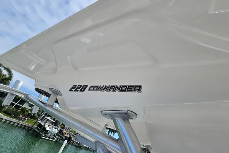 Slide: The Image of 2020 Sea Fox 228 Commander boat detail with logo, docked near waterfront homes. - 11