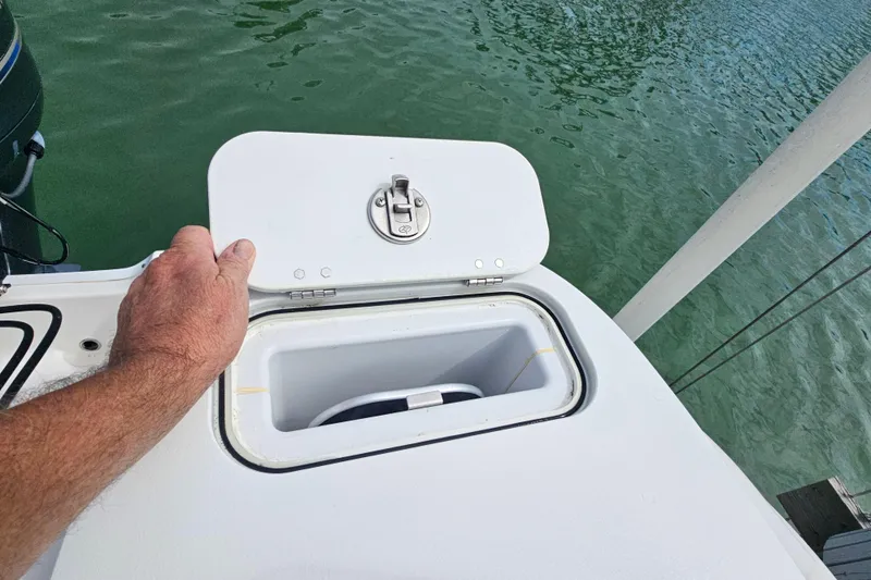 Slide: The Image of Hand opening storage compartment on 2020 Sea Fox 228 Commander boat. - 16