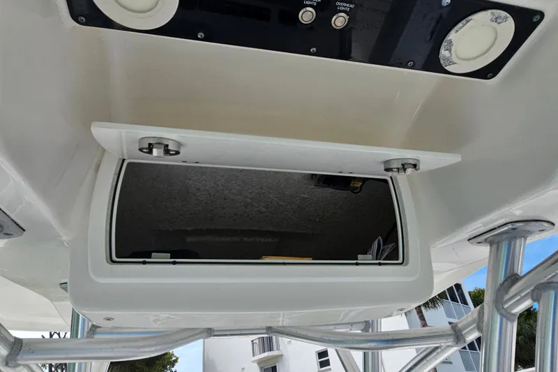 Slide: The Image of 2020 Sea Fox 228 Commander boat console storage compartment with open hatch and control panel. - 19