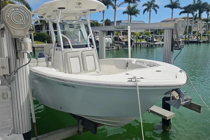 Slide: The Image of 2020 Sea Fox 228 Commander boat docked on a lift in a marina. - 2
